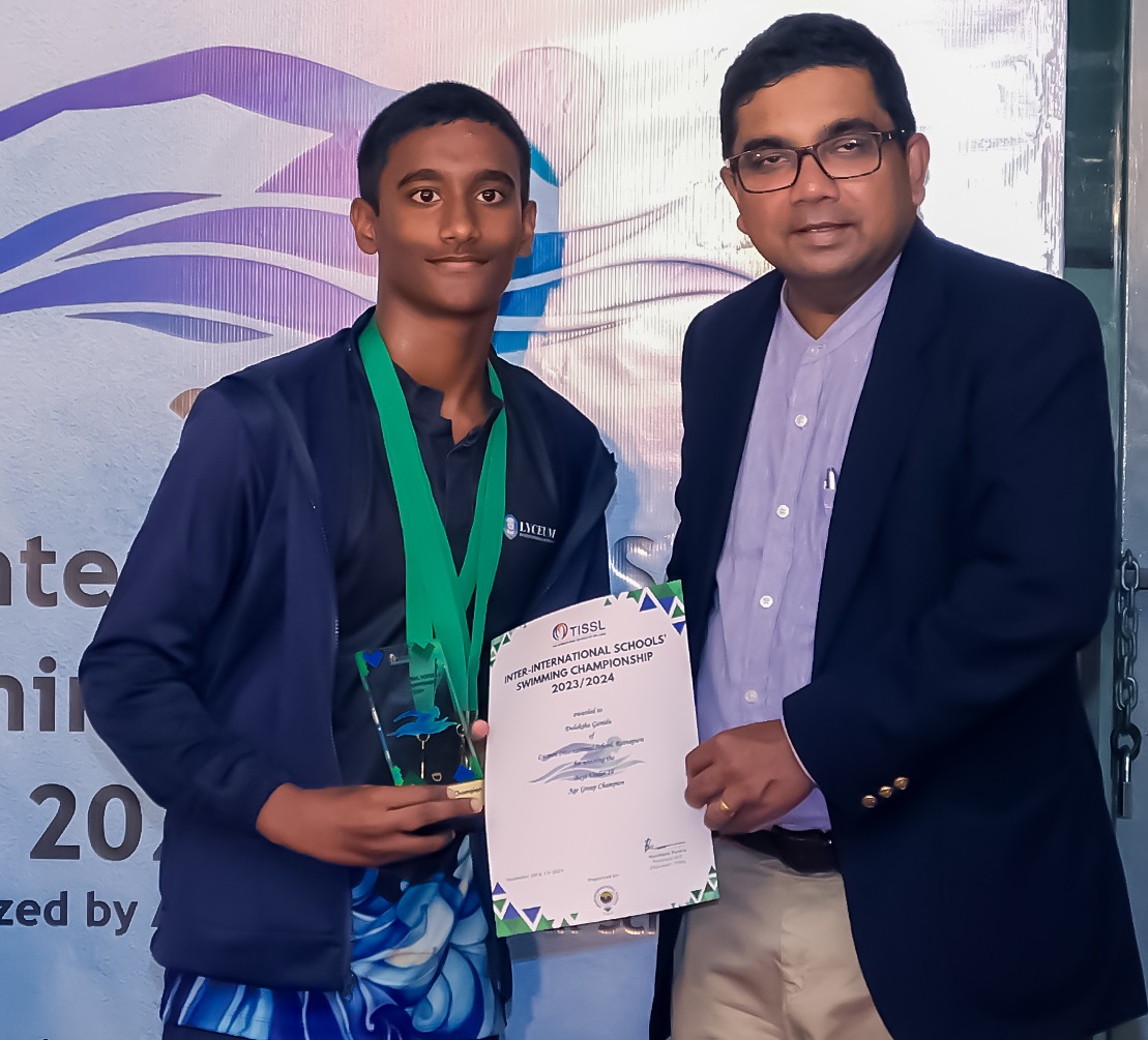 Young athlete and coach celebrate with trophy and certificate at 2019 International Championship.