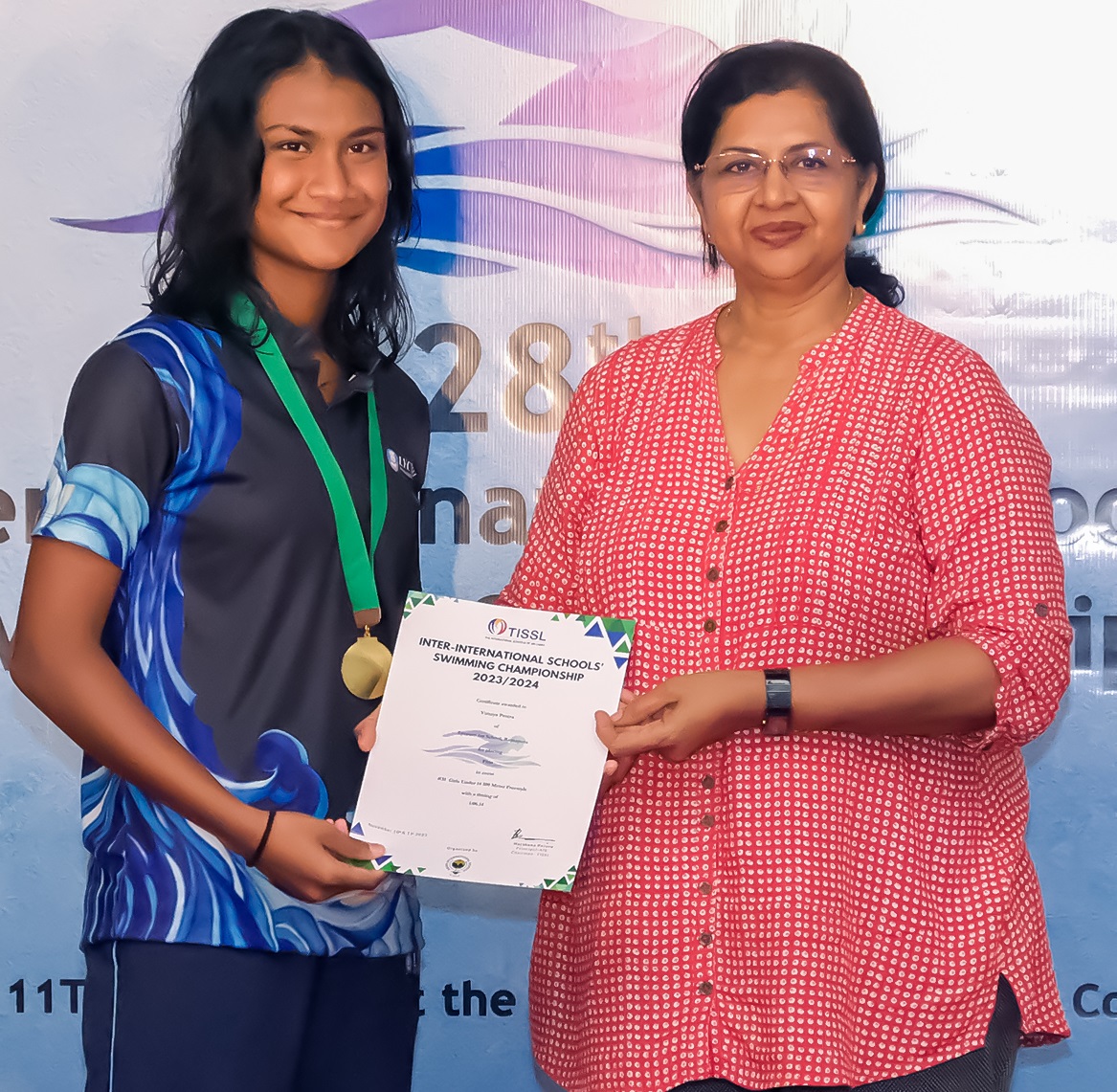 Young swimmer receives award at 28th Annual Swimming Championships.