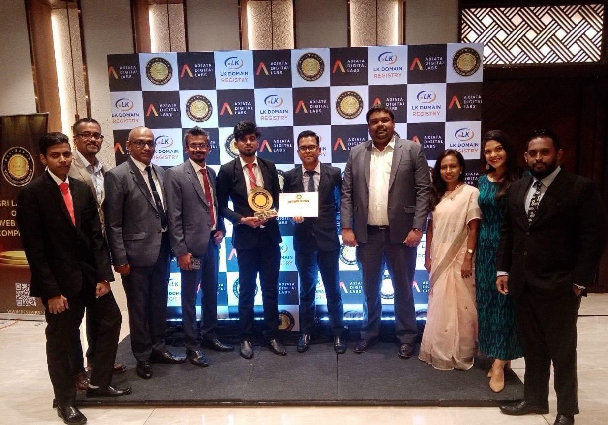 A diverse team celebrates an award at a corporate event.