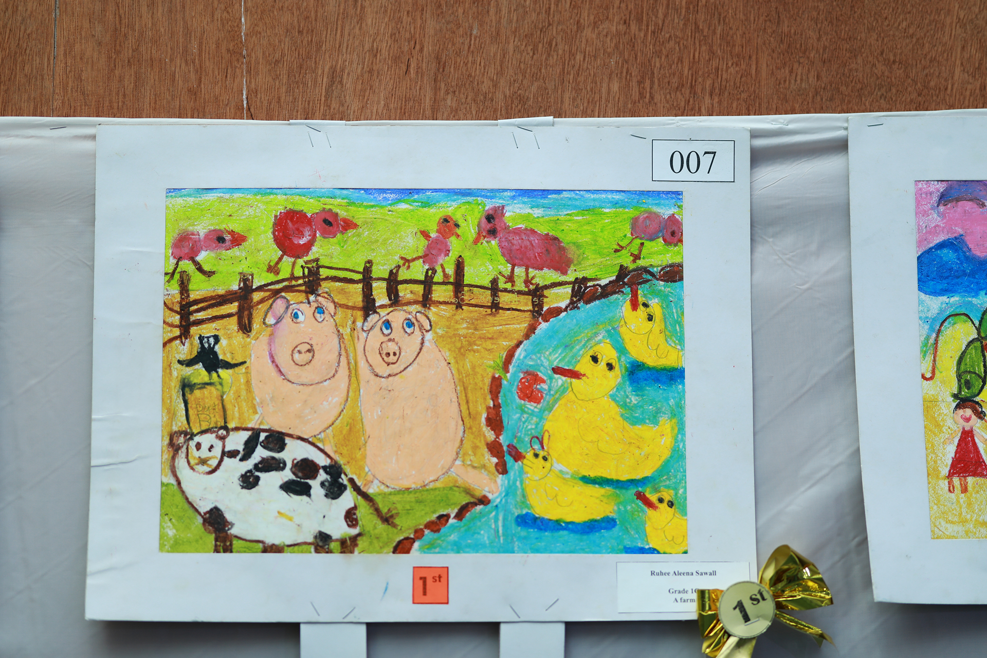 Colorful child’s farm drawing with pigs, cow, sheep, ducks, pond, rooster, horse, hills, and sky.