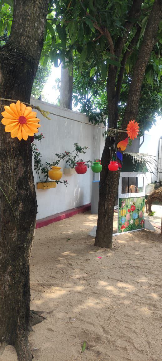 Outdoor play area with colorful decorations and a bright playhouse.