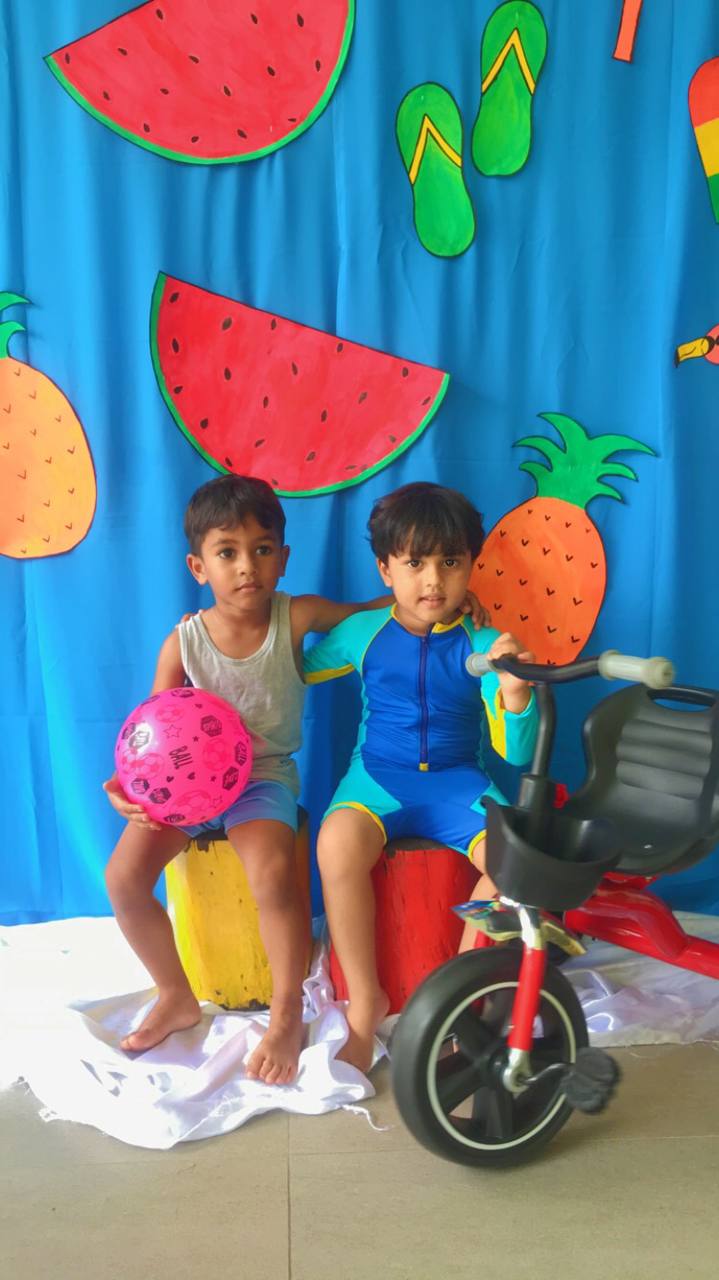 Children enjoying summer fun with bright decorations and playful activities.