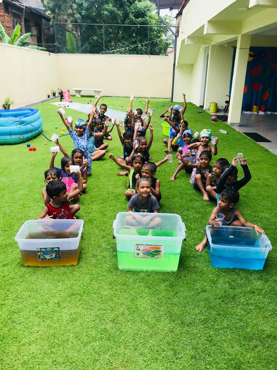 Children in swimwear enjoying colorful water activities on a sunny day.
