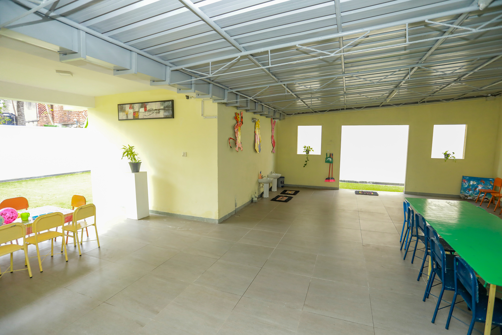 Bright childrens playroom with colorful furniture, natural light, and organized storage.