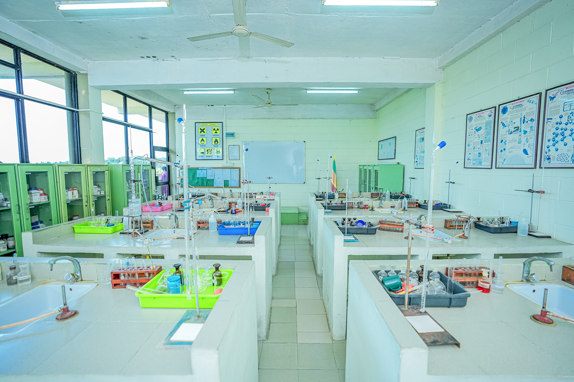 Well-lit science lab with organized workstations and storage cabinets.