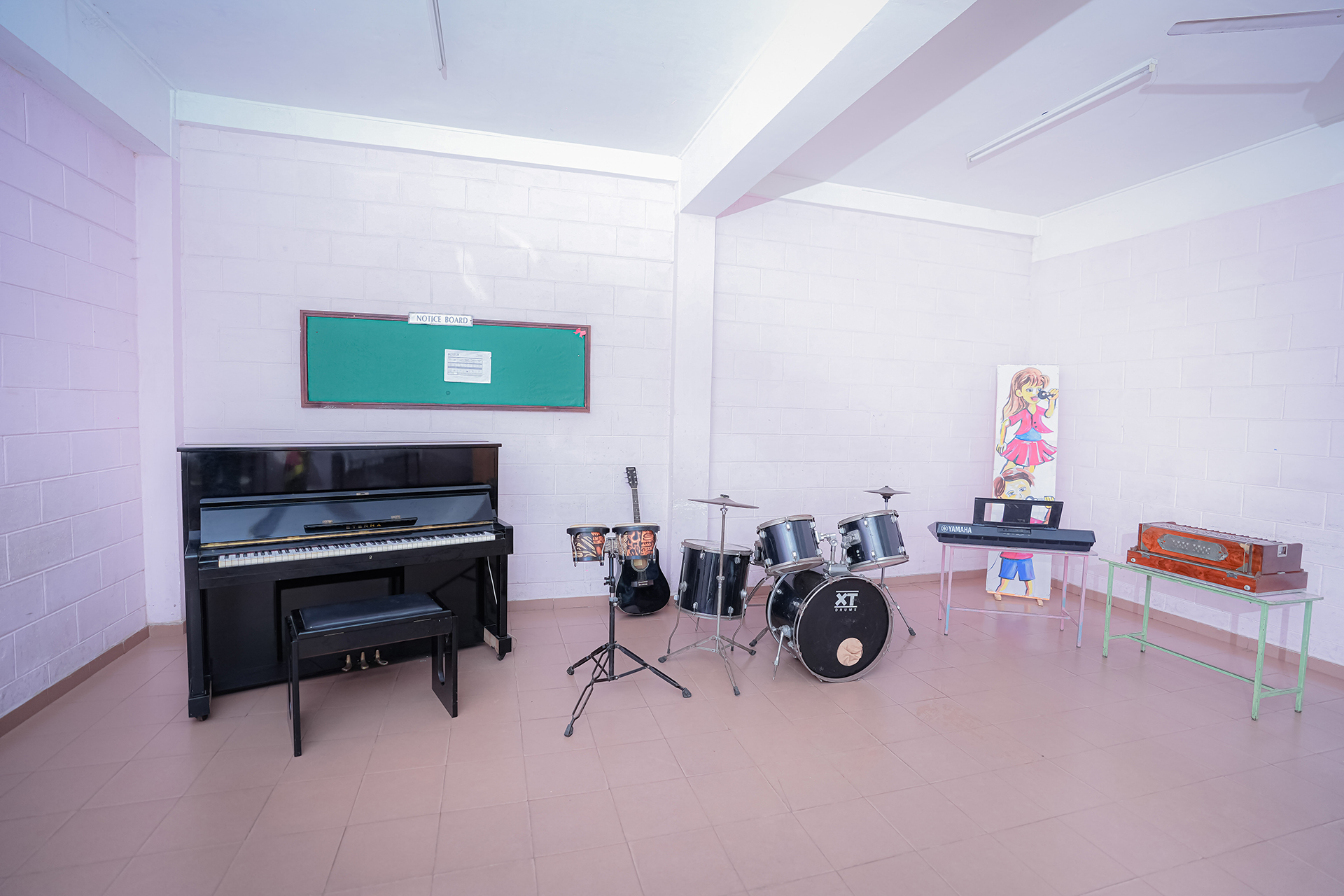Spacious music room with piano, drums, guitar, and keyboard.