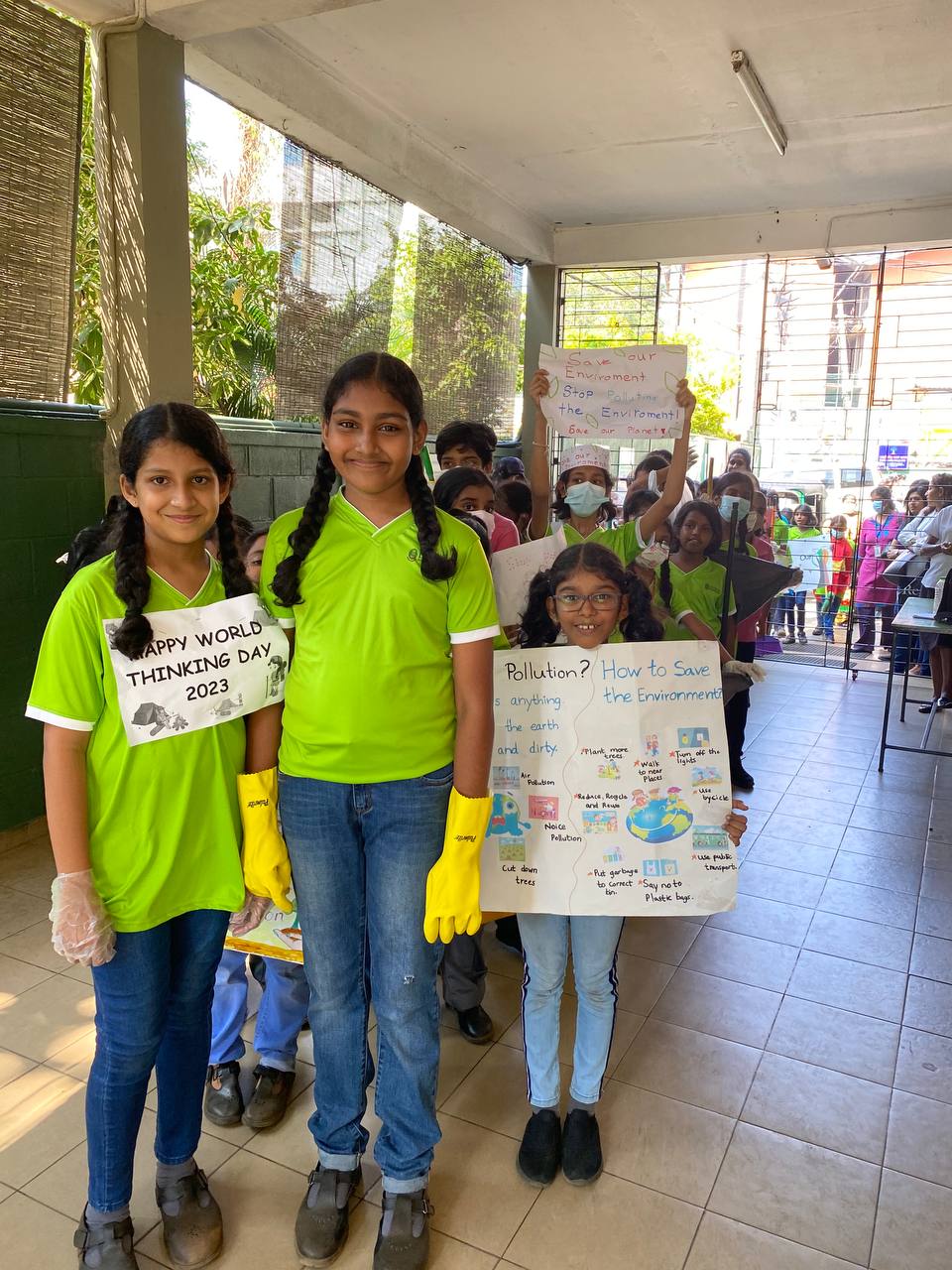 Children celebrate World Thinking Day 2023 with eco-friendly activities and educational posters.