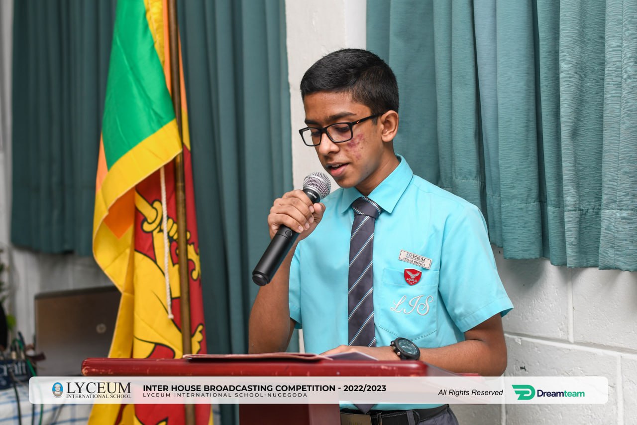 Young boy speaking at Lyceum Inter House Broadcasting Competition 2022/2023.