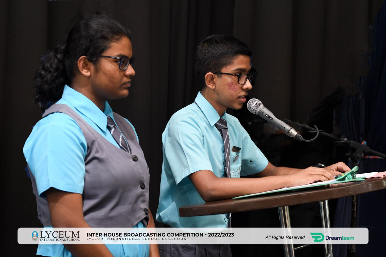 Two students presenting at Lyceums Inter House Broadcasting Competition 2022/2023.