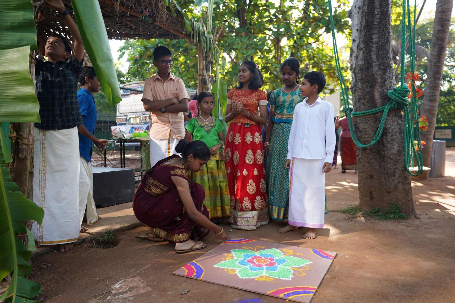 Traditional Rangoli creation in nature during a cultural celebration.