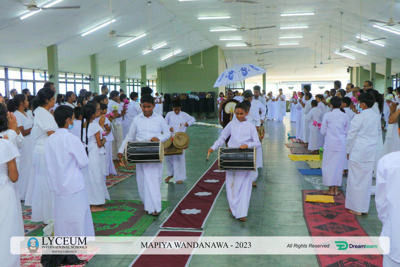 Lyceums 2021 MAPYA WANDANAWA ceremony with participants in white, barefoot, playing drums.