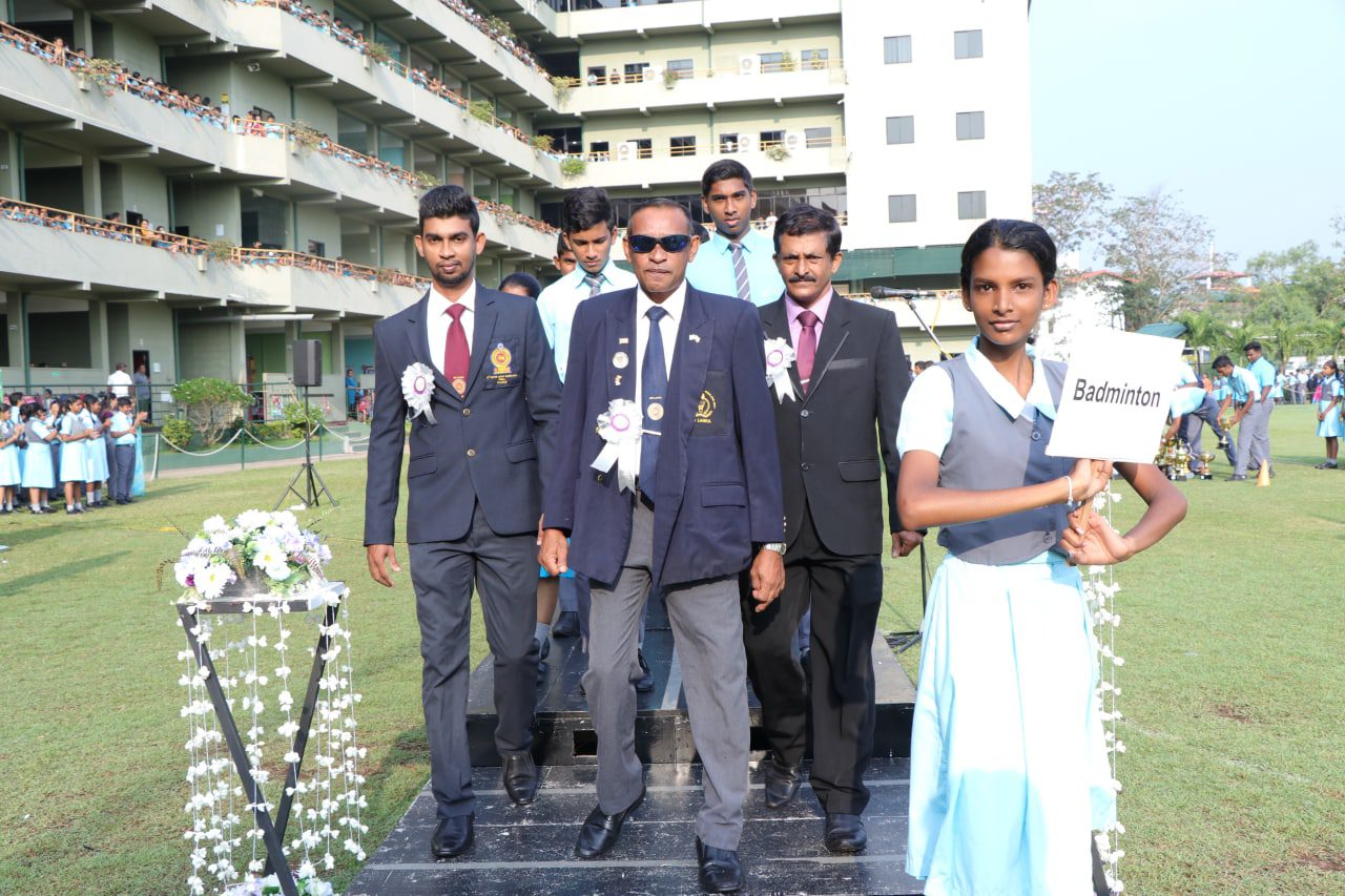 School officials and students gathered at a welcome ceremony outdoors.