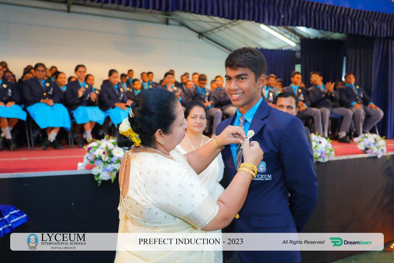 Student receiving badge at Lyceum Prefect Induction Ceremony 2023.