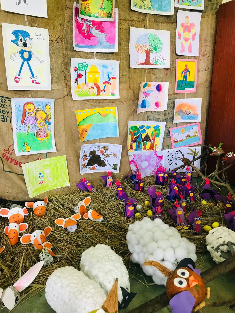 Childrens colorful artwork and handmade crafts on display at a community event.
