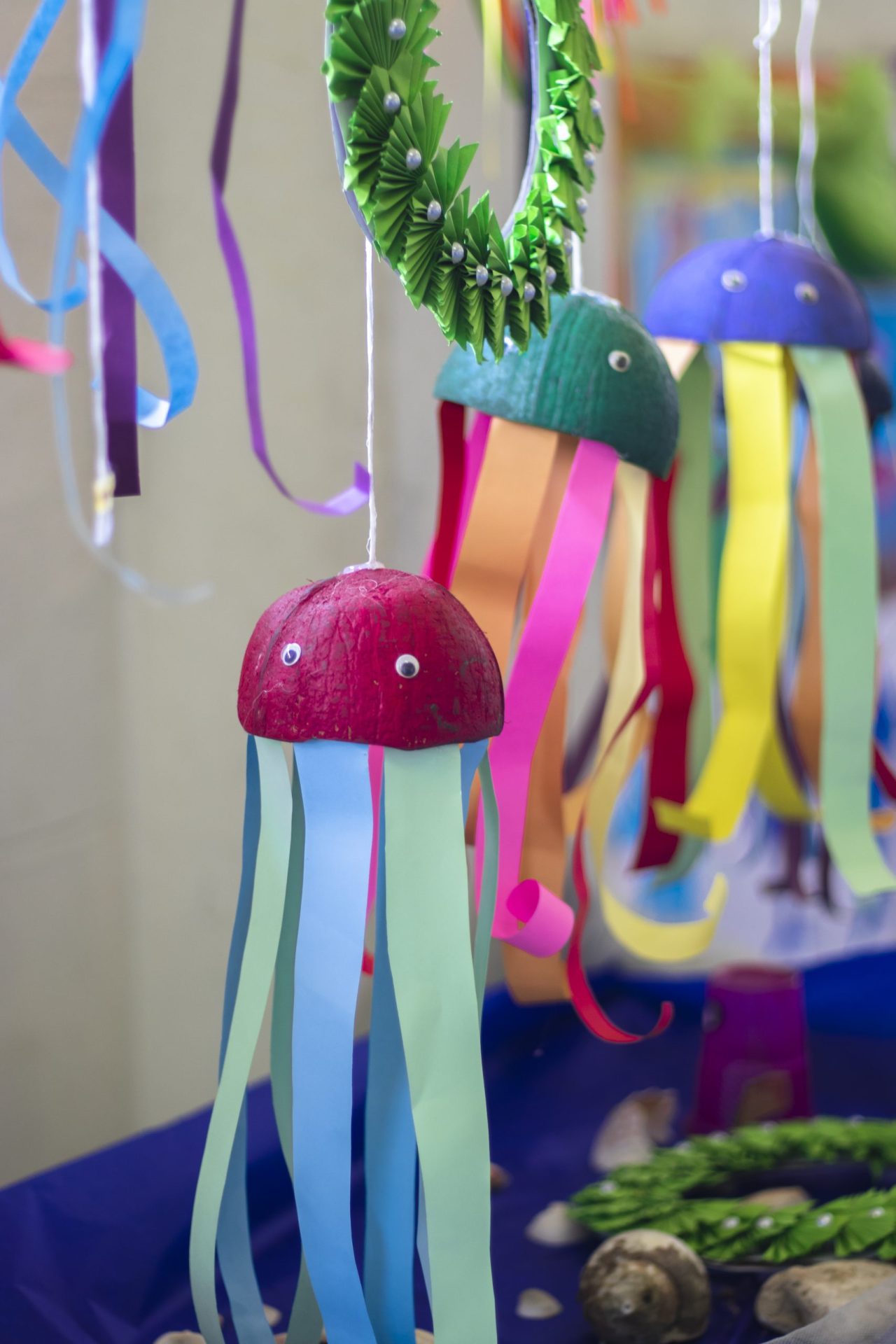 Whimsical jellyfish crafts with googly eyes and colorful ribbon tentacles.