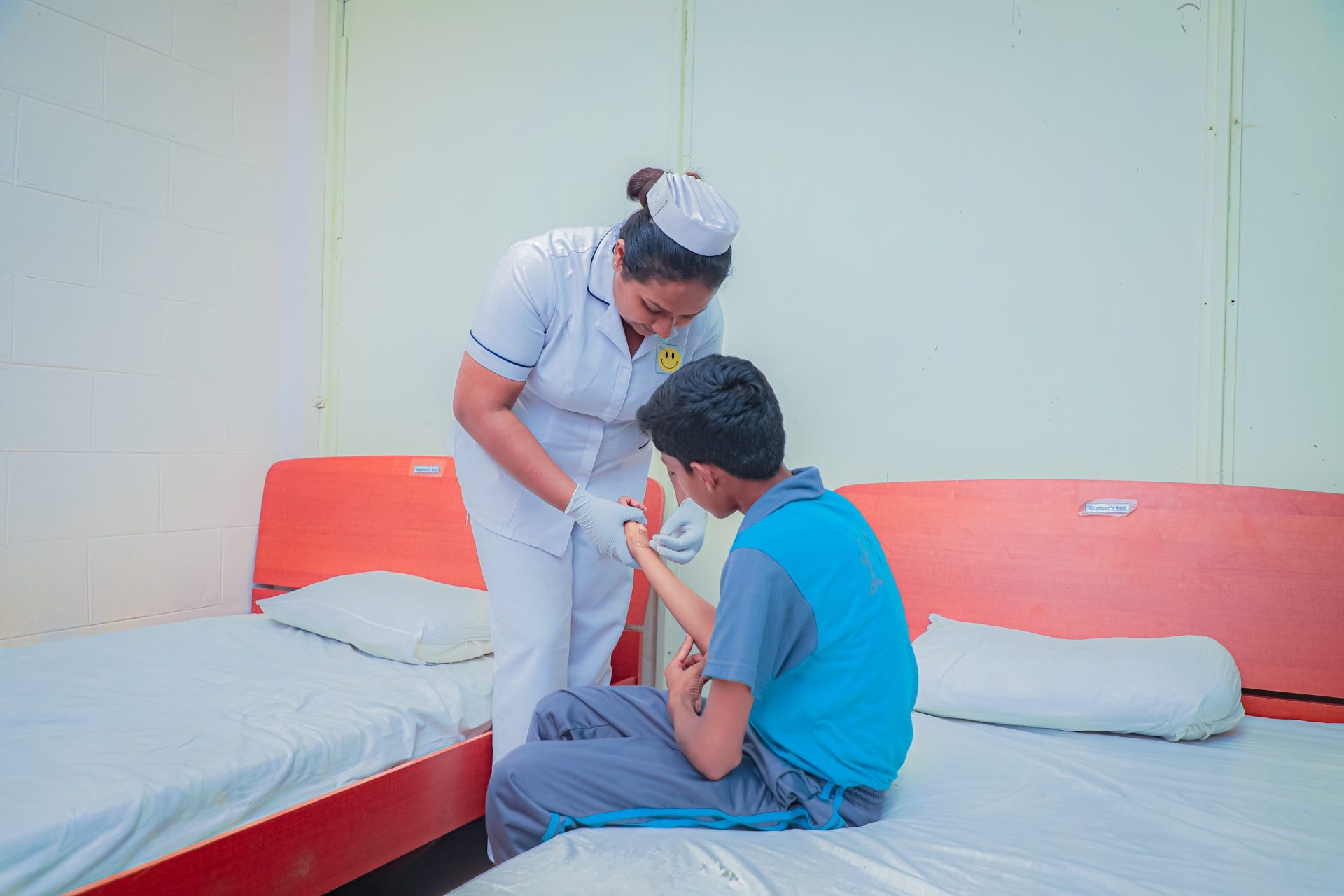 Nurse providing attentive care to a patient in a clean, minimalist hospital room.