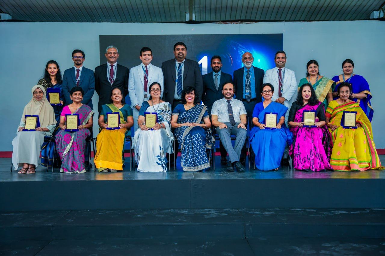 Achievement Awards Ceremony: Group Photo of Honorees Award ceremony group photo with recipients holding plaques, wearing traditional and formal attire.
