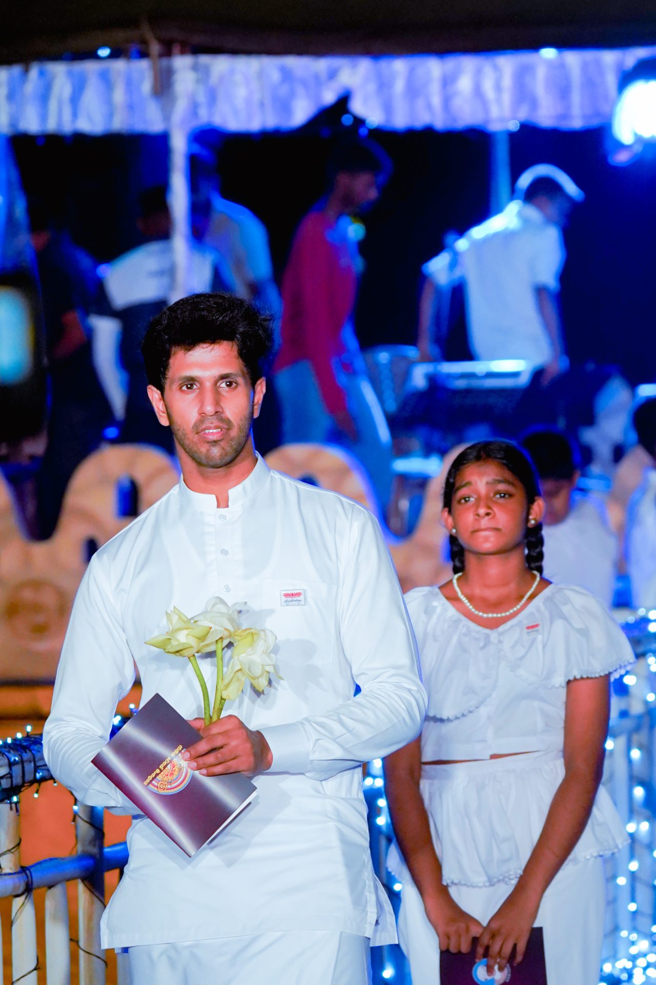 Man and girl in white at solemn traditional ceremony event.