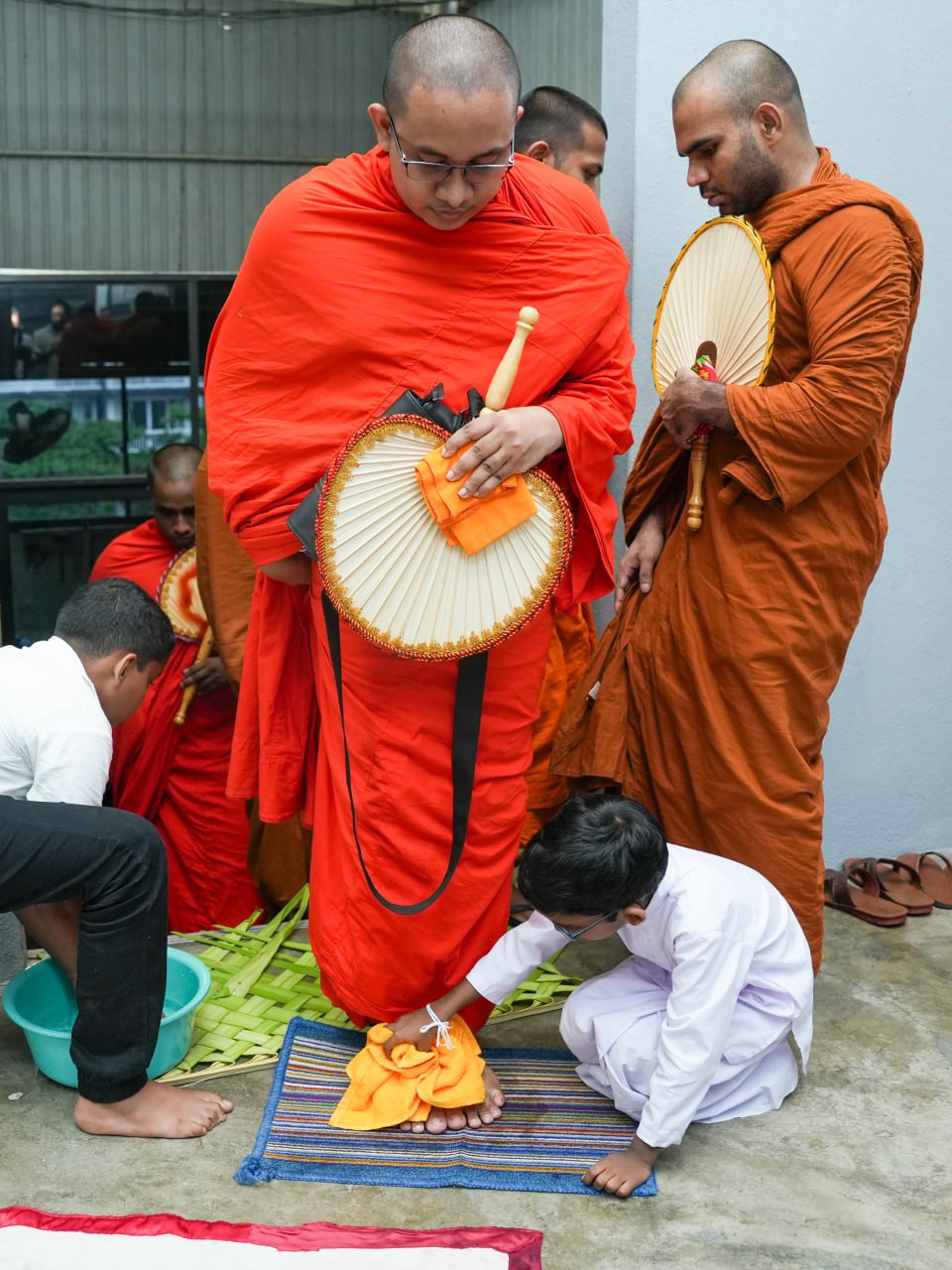 Buddhist monks perform a sacred ritual with lay devotees in a serene temple.