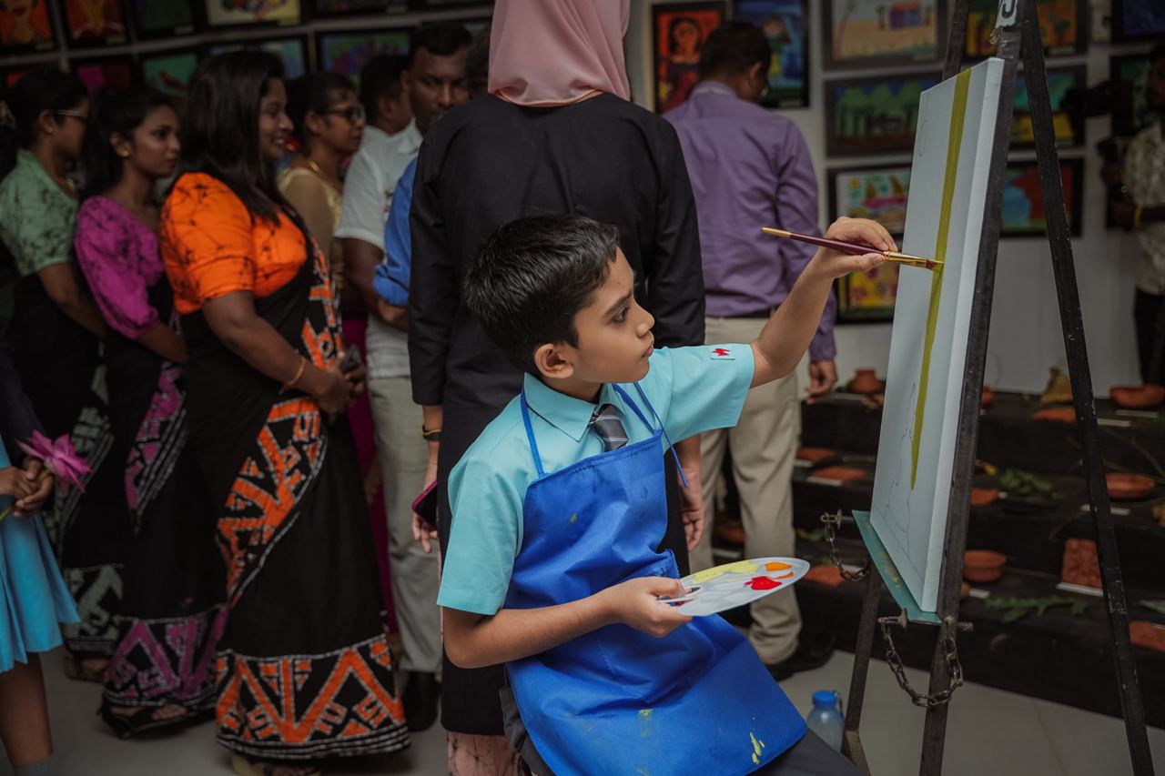 Young Boy Painting at a Community Art Exhibition Young boy painting at a vibrant community art exhibition.