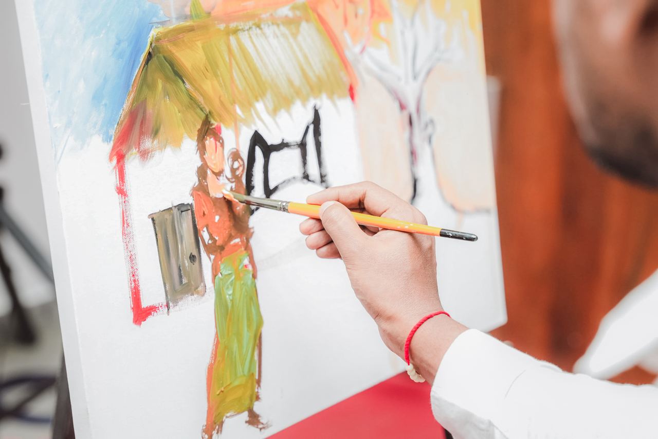 Rural Life on Canvas: An Artists Creative Process Artist painting rural scene on canvas with vibrant colors.