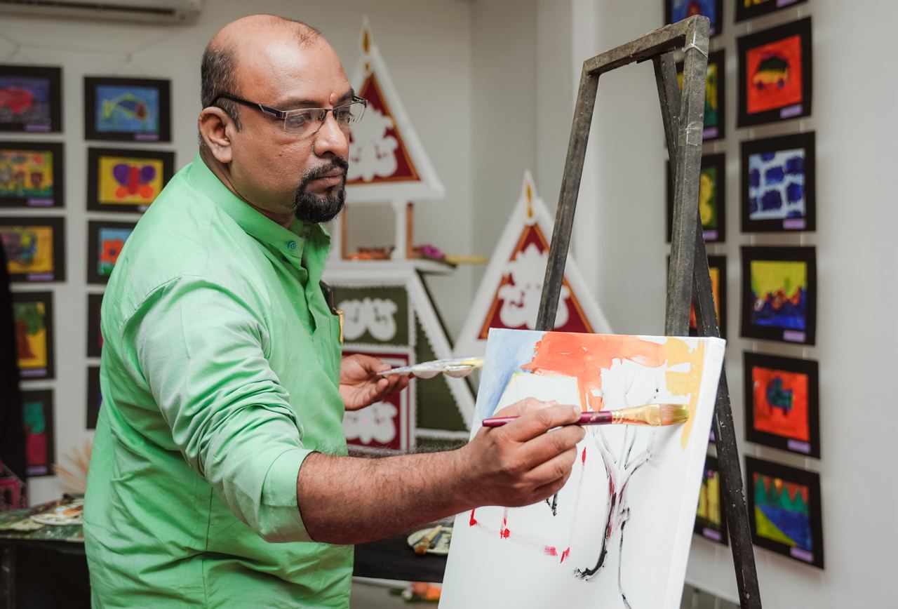 Creative Artist Focused in Vibrant Studio Focused artist painting in studio with colorful childrens artwork on walls.