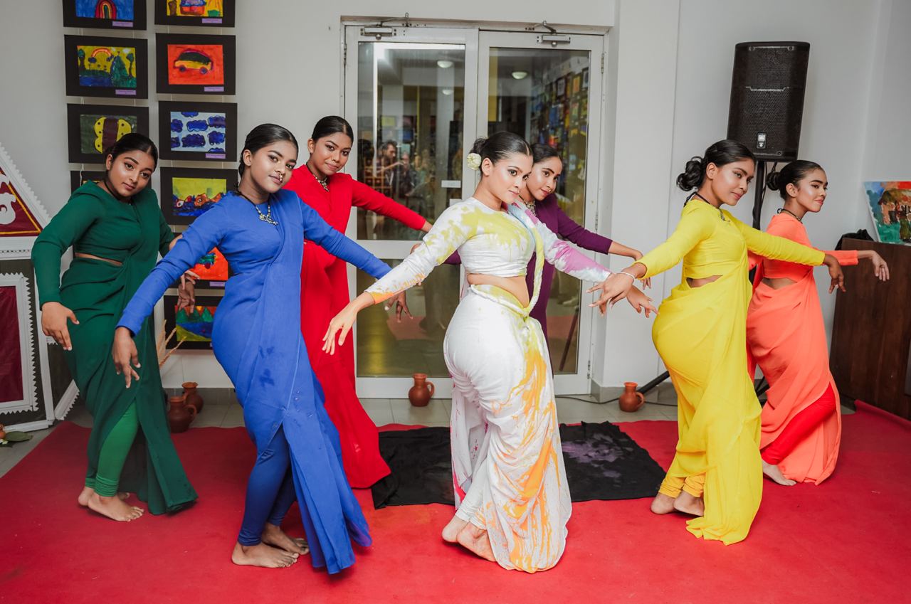 Vibrant Cultural Dance in Colorful Saris Traditional dance performance featuring seven women in colorful saris, illustrating cultural celebration.
