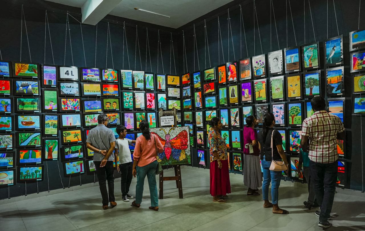 Vibrant Art Gallery with Colorful Paintings and Butterfly Project Art gallery showcasing colorful, diverse paintings and a collaborative butterfly project, with engaged visitors.