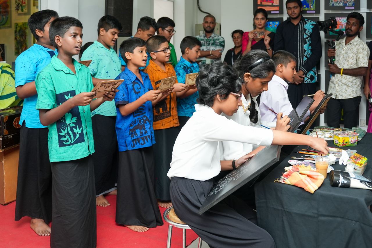 Childrens Cultural Art and Singing Event Children engaged in singing and painting during a cultural activity at a community center.