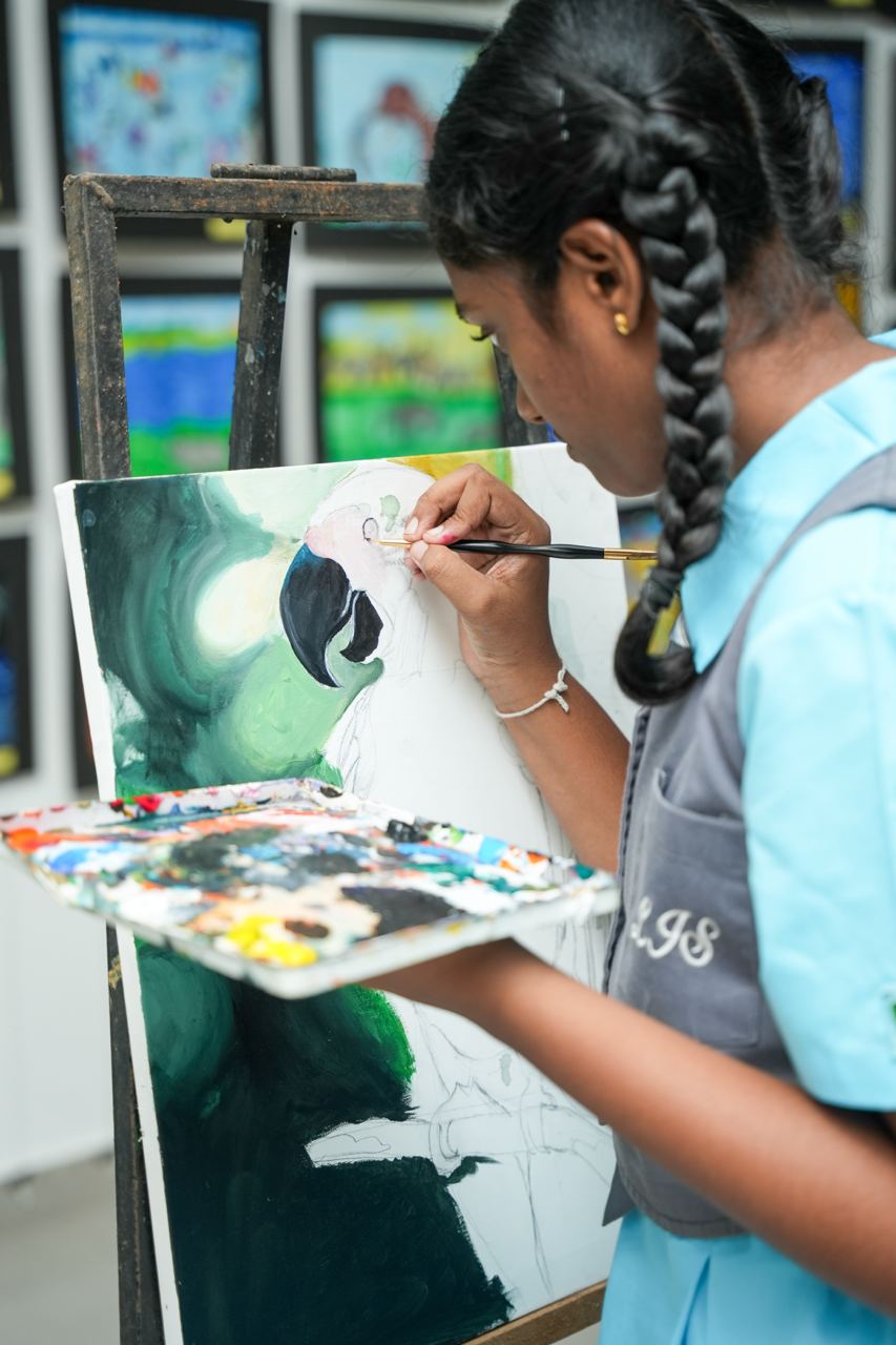 Young Artist Painting a Parrot in Art Class Young student artist painting a bird on canvas in art classroom.