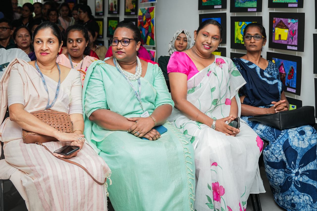 Women Celebrating Art in Traditional Attire Women in traditional attire at a community art event.