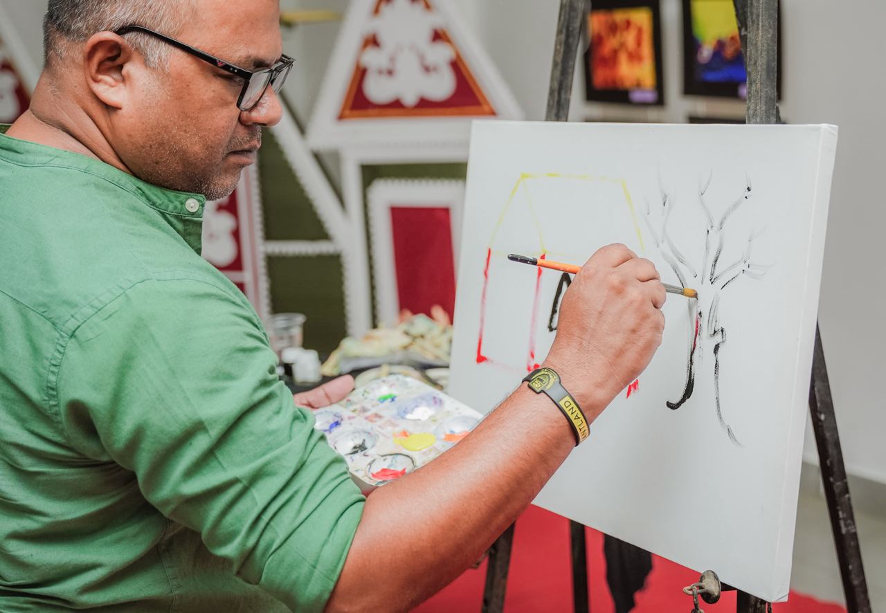 Artist Creating Vibrant House and Tree Painting in Studio Artist painting vibrant house and tree on canvas in studio.