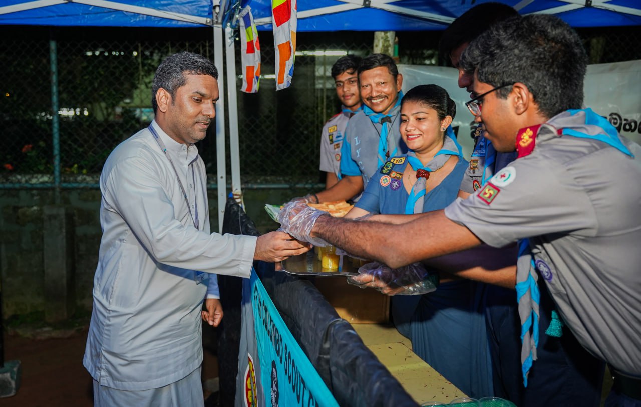 Community Leader Served by Cheerful Scouts at Outdoor Event Community leader receives food from cheerful scouts at outdoor event.