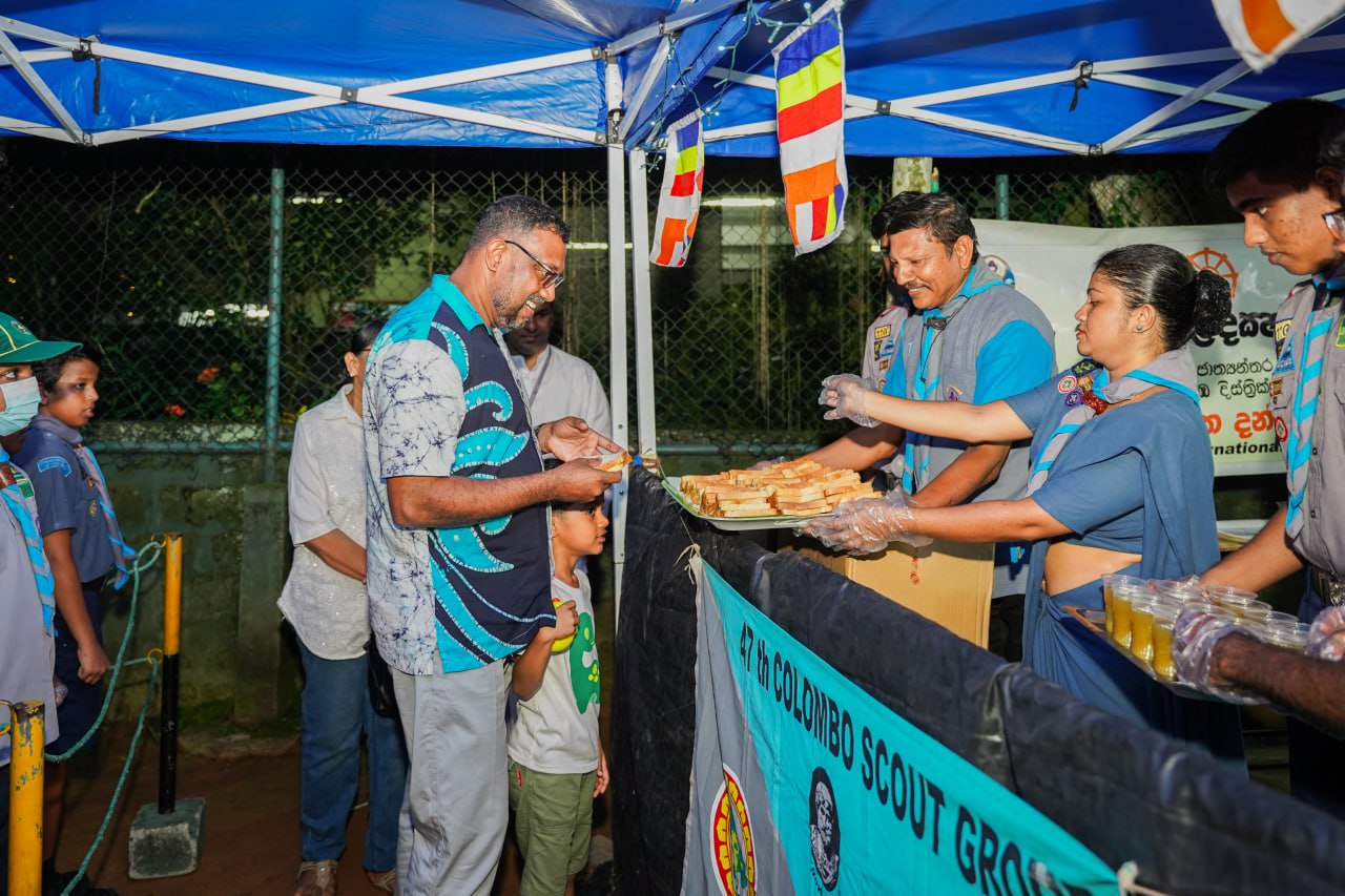 47th Colombo Scouts Evening Community Food Fest Community food fest by 47th Colombo Scouts with volunteers serving under a blue canopy.