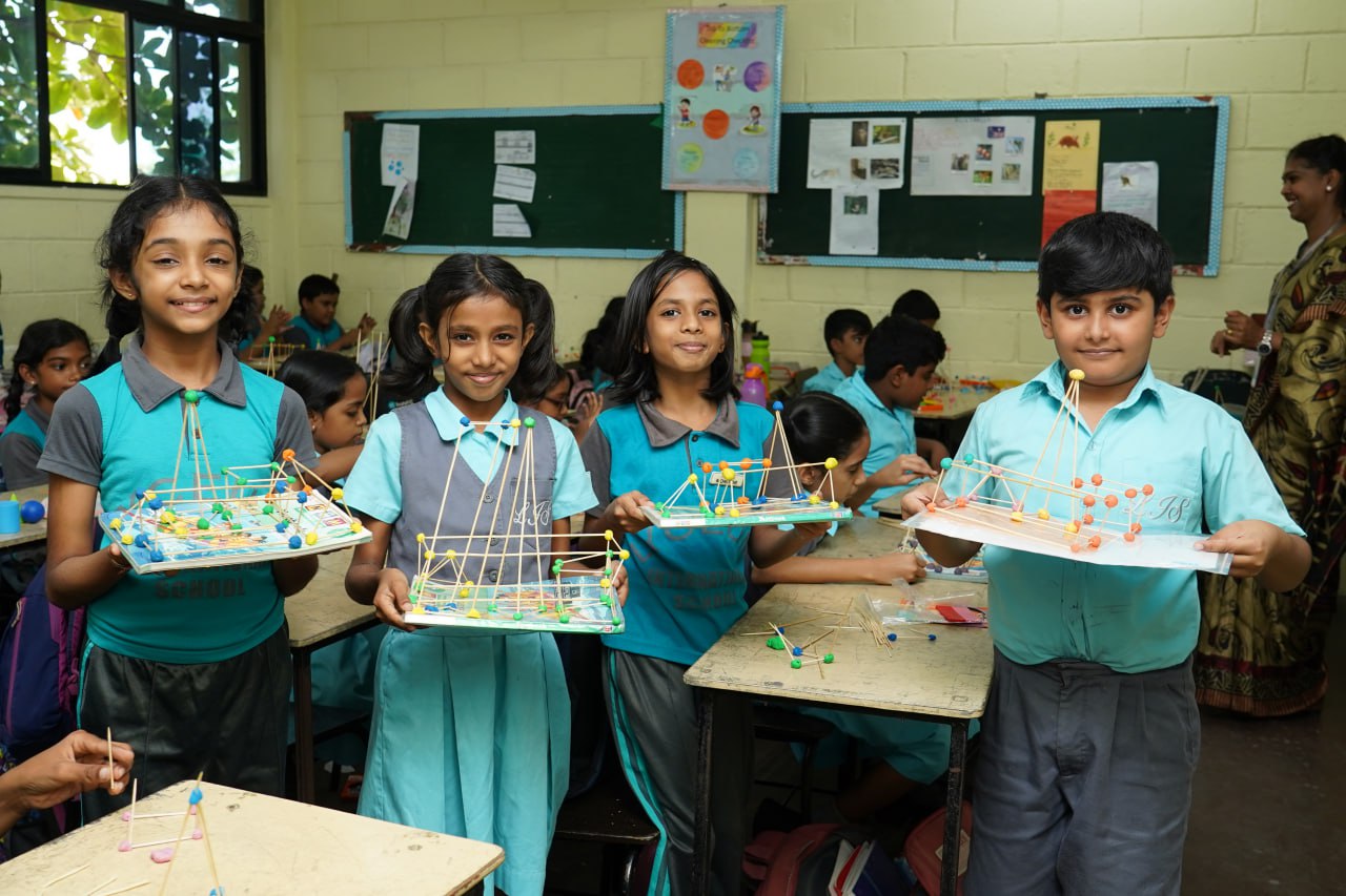 Hands-On STEM Fun in the Classroom Students proudly show off colorful STEM projects in a vibrant classroom.