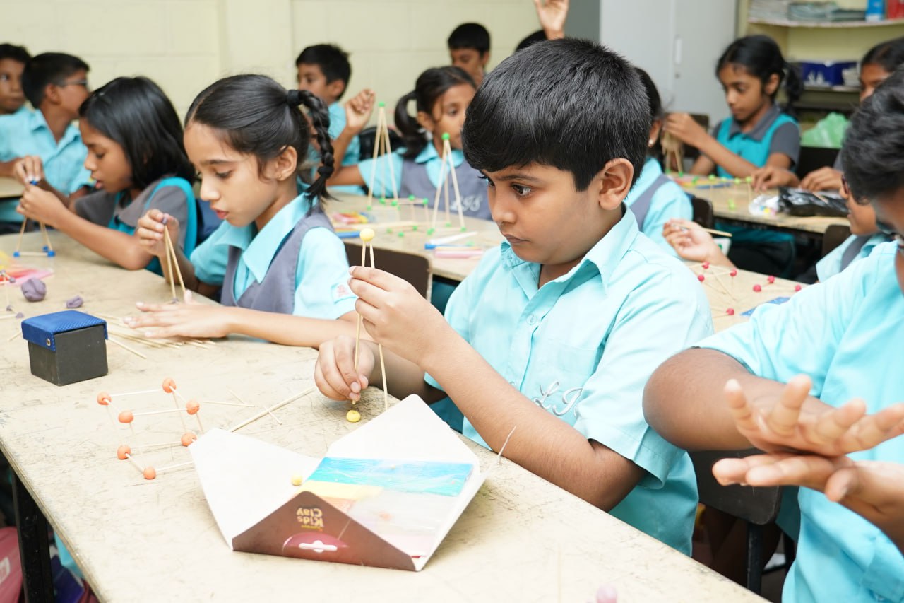 Creative Classroom Geometry Activity Students building geometric shapes with clay and sticks in an engaging classroom activity.