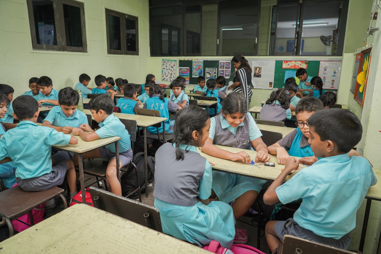 Dynamic Classroom Collaboration in Action Students actively engaged in hands-on group projects in a vibrant classroom setting.