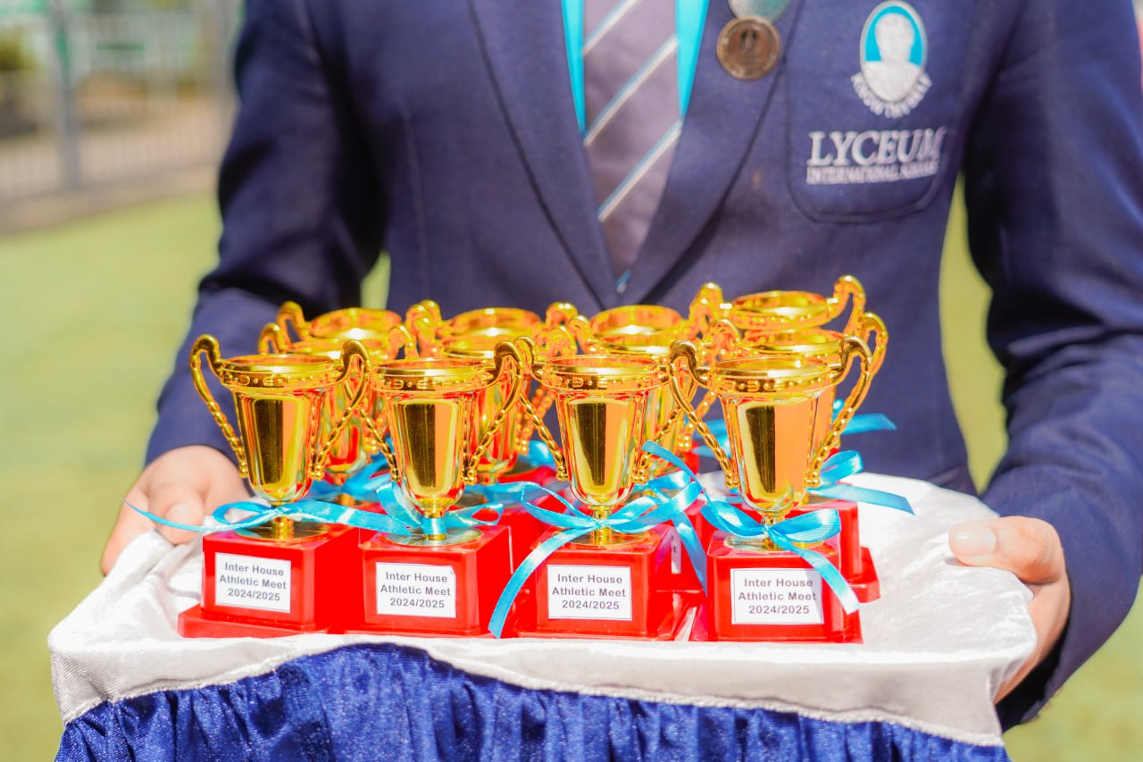 Lyceum School sports trophies arranged for 2024/2025 athletic meet, highlighting student achievements.