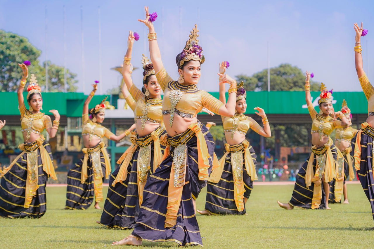 Elegant traditional dance in ornate costumes outdoors, celebrating cultural heritage.