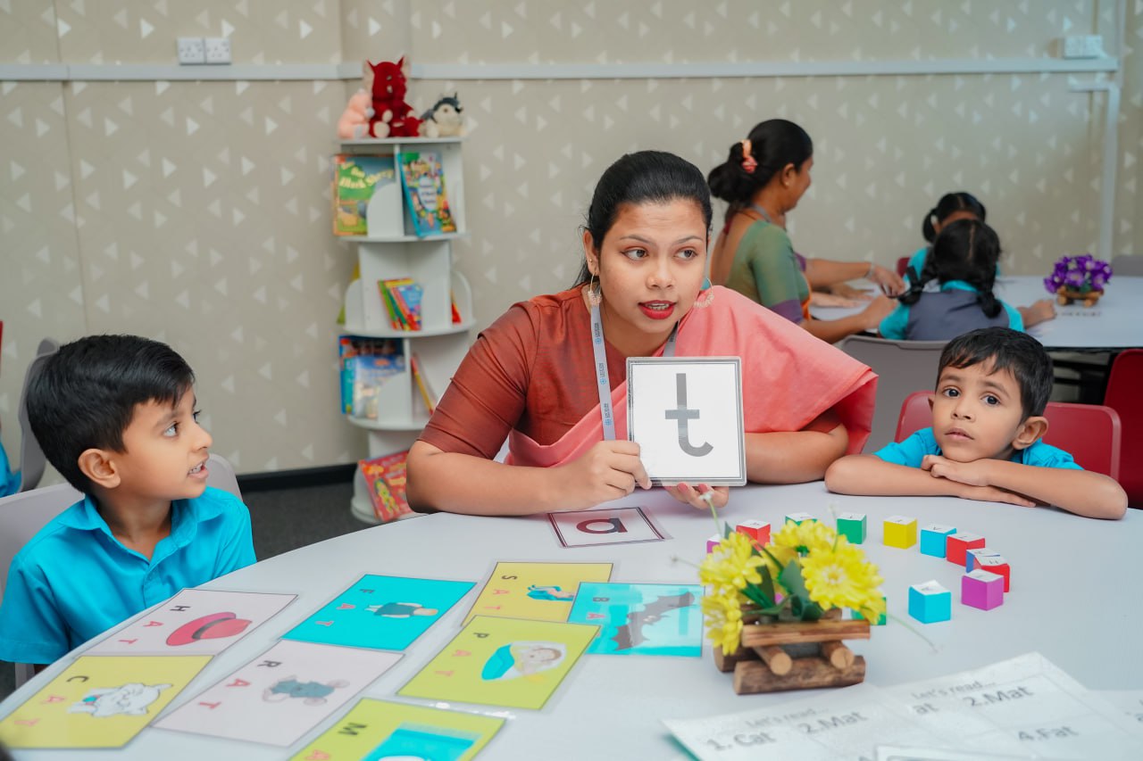Interactive Phonics Lesson in Multicultural Classroom Teacher in saree leads interactive phonics lesson with children in colorful, multicultural classroom.