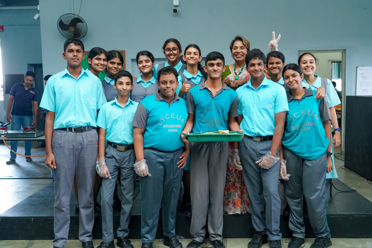 Lyceum students bond over a food prep activity, highlighting teamwork and school spirit.