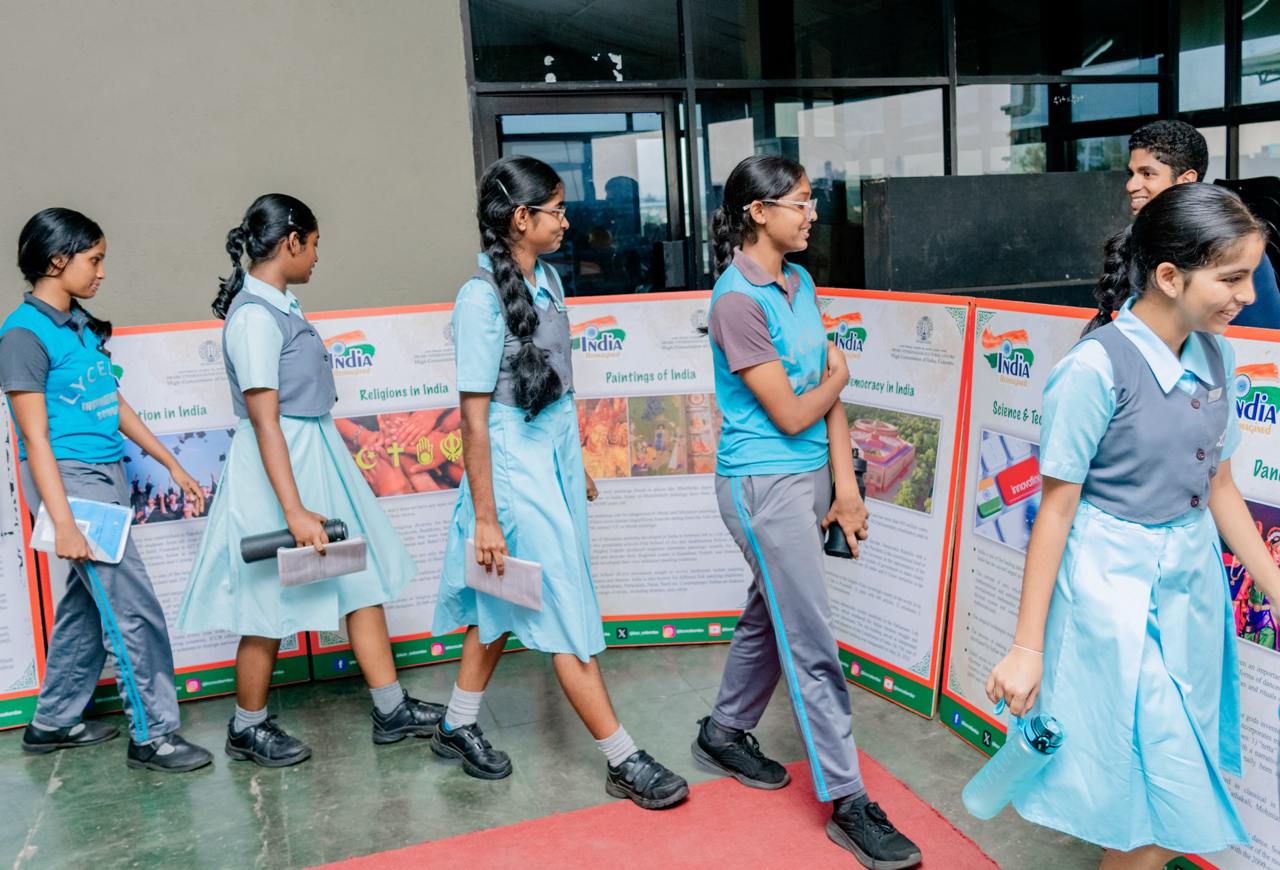 Schoolchildren explore Indian culture and technology at an educational exhibit.