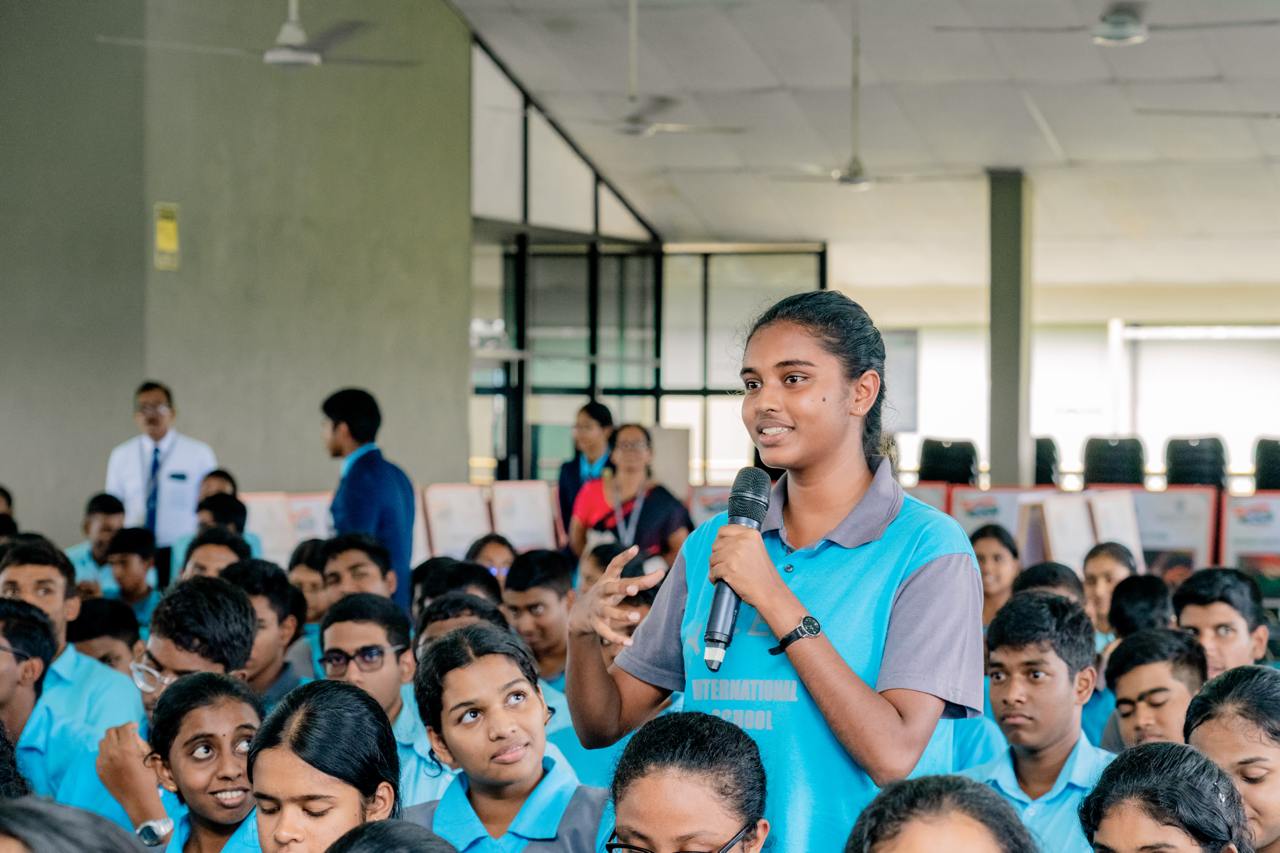 Young woman leads interactive discussion in a vibrant educational workshop setting.
