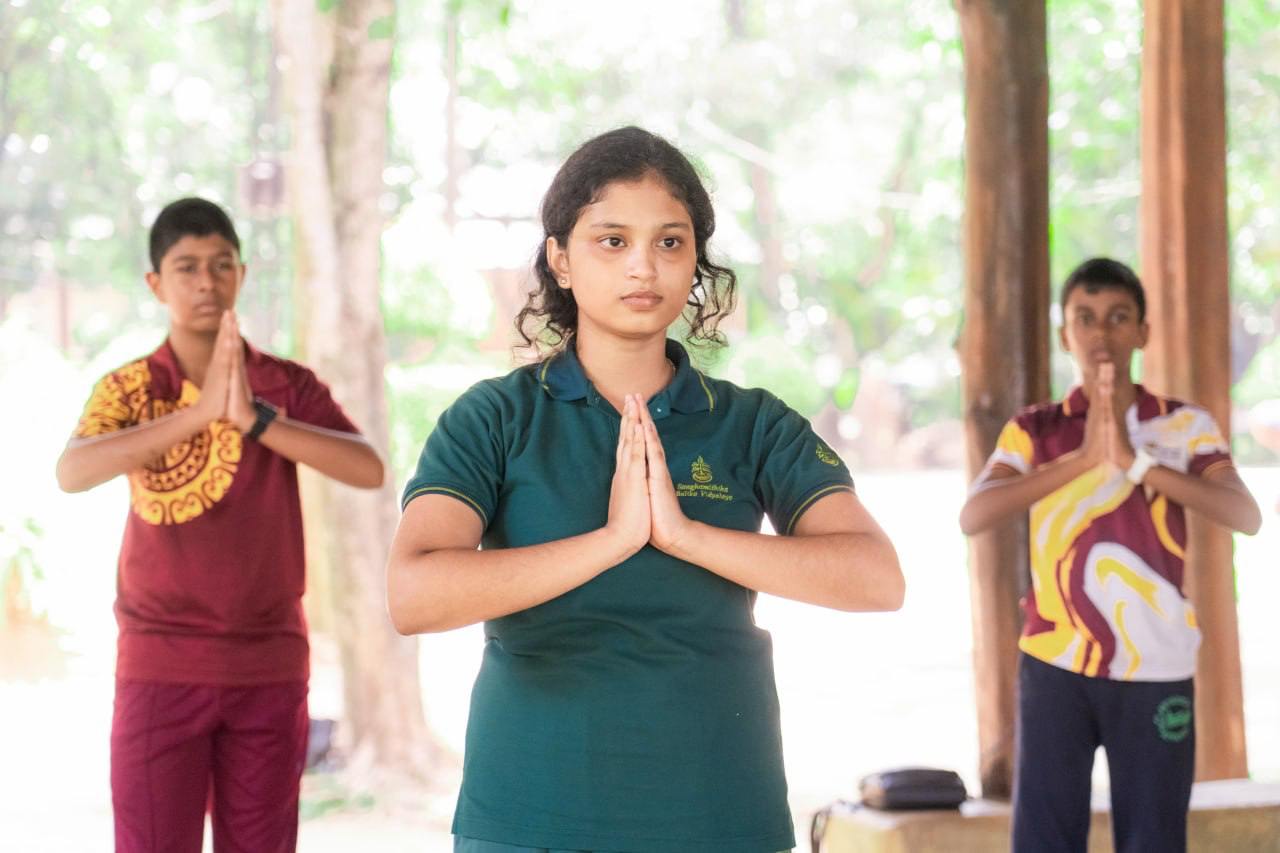 Teenagers practicing yoga outdoors under a pavilion, embodying peace and unity amidst natures tranquility.