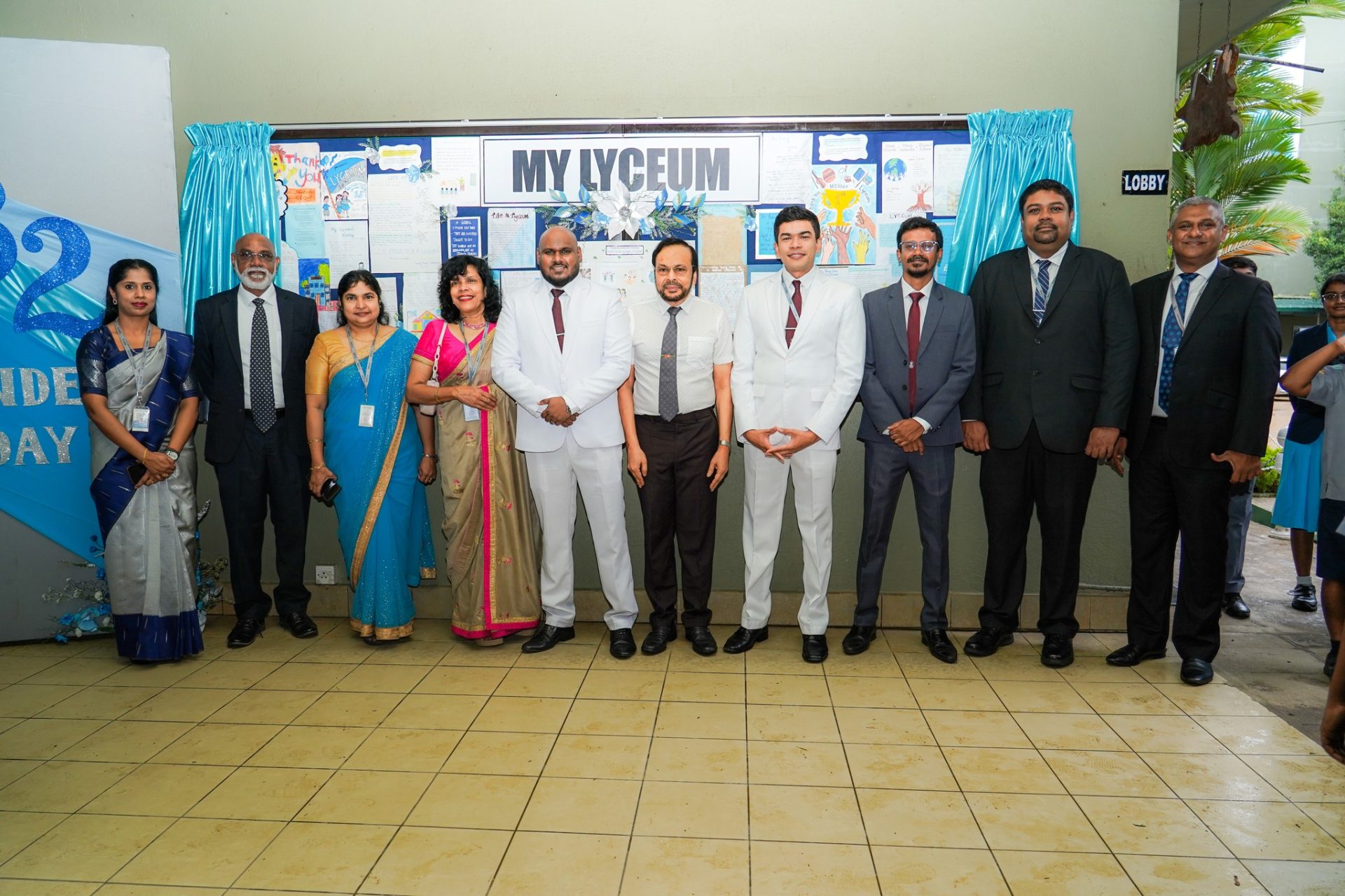 School Independence Day Celebration With Faculty and Guests School Independence Day celebration group photo with teachers, administrators, and honorees in formal attire.