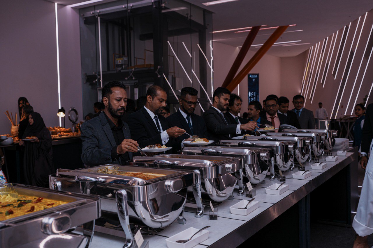 Executive Networking Buffet at Modern Corporate Event Corporate buffet event with business professionals in suits, modern venue, multicultural networking, gourmet catering.