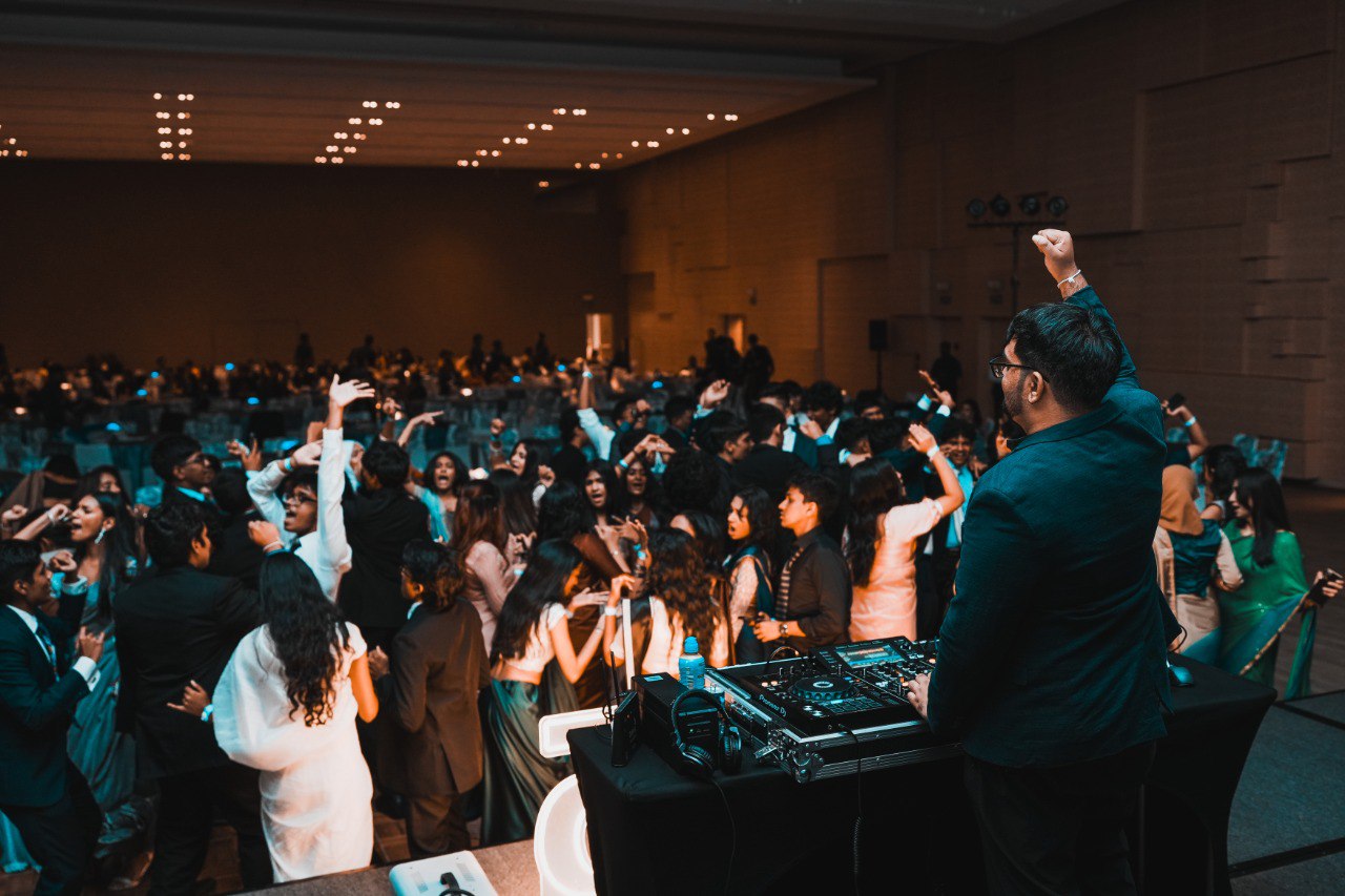 Elegant Wedding Reception Dance Party With DJ and Guests Elegant wedding reception dance floor with DJ, guests in formal attire, lively party celebration.