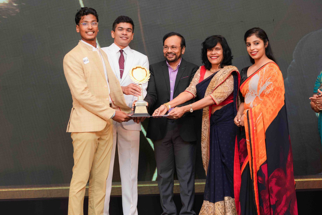 Proud Winners Celebrate at Awards Ceremony Stage Award ceremony winners posing with trophy and certificate on stage with dignitaries in formal attire.