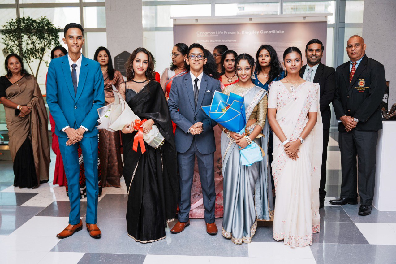 Graduation Celebration With Award Winners and Faculty in Sarees and Suits Award ceremony group photo with young graduates, faculty, and families in sarees and suits indoors.