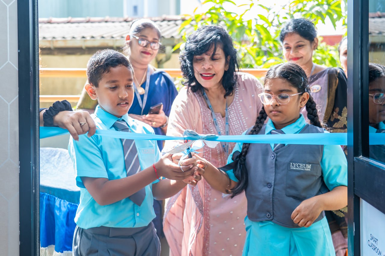 School ribbon-cutting ceremony with students and teachers at Lyceum International School opening event.